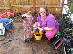 Emma helping me plant rosemary, thyme, basal and pretty pink fuzzies - or chives.  She had a blast.